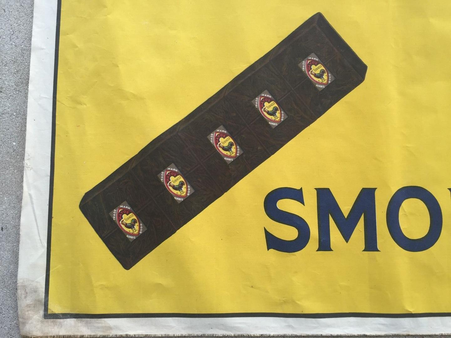 Uncut plug tobacco with tin tags inserted as it would appear in the box. A section of plug with tag would be cut for the customer at the store with a tobacco cutter.